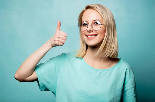 Estilo mujer rubia en gafas muestran gesto OK sobre fondo azul —  Fotos de Stock