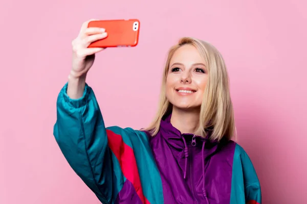 Piękna blondynka zrobić selfie na różowym tle — Zdjęcie stockowe