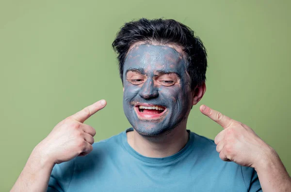 Chico Una Máscara Cuidado Facial Sobre Fondo Verde —  Fotos de Stock