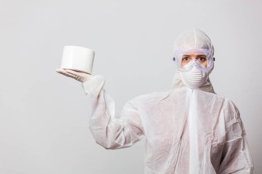 young doctor in protection suit and glasses with mask with toilet paper on white background clipart
