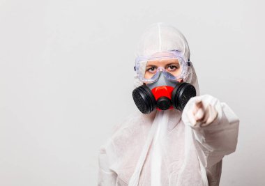 Koruyucu giysili kadın doktor ve maskeli gözlüklü.