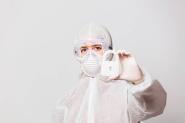 Koruyucu giysili kadın doktor ve maske takan gözlük kilit altında.