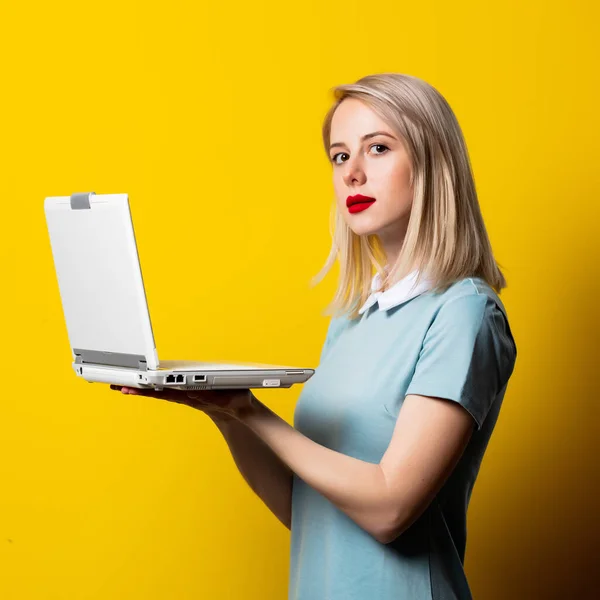Blond Meisje Blauwe Jurk Met Laptop Computer Gele Achtergrond — Stockfoto