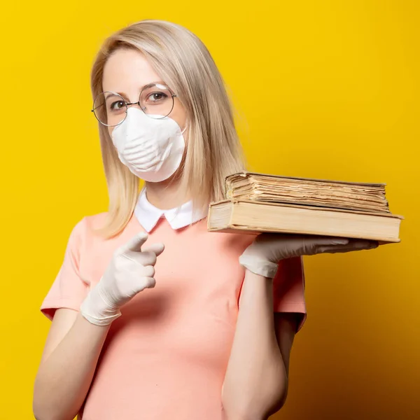 Blonde Girl Face Mask Pink Dress Holding Book Yellow Background — Stock Photo, Image