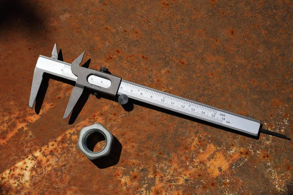 Metal calliper and nut — Stock Photo, Image