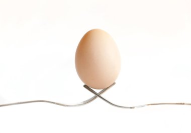 Paskalya yortusu yumurta beyaz zemin üzerine çatal üzerinde tutulması