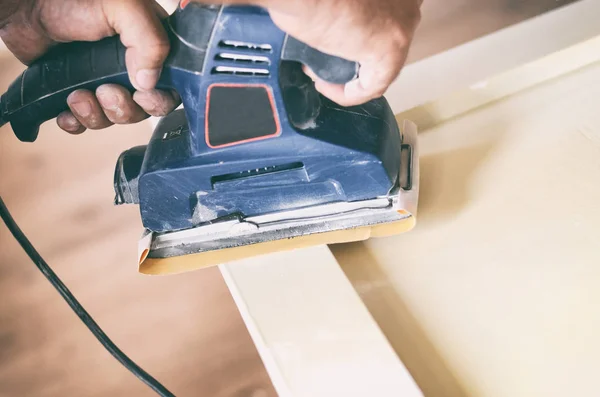 Orbital sander in use, sanding old door for a new lick of paint. — Stock Photo, Image