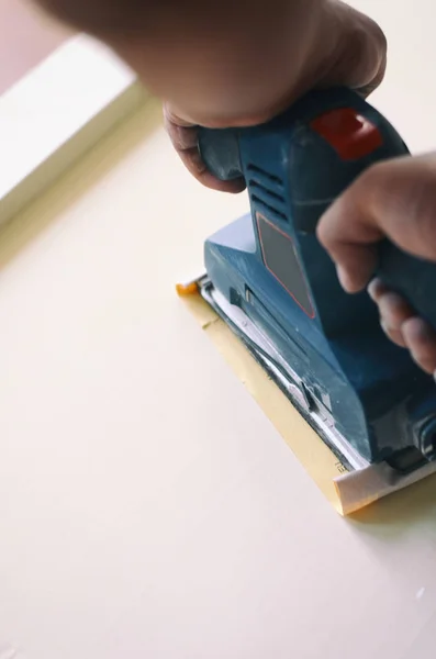 Orbital sander in use, sanding old door for a new lick of paint. — Stock Photo, Image