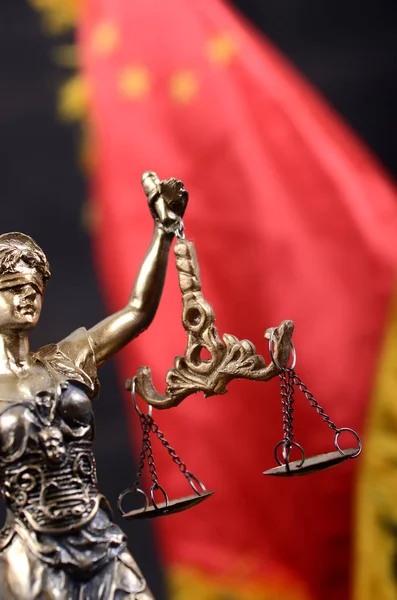 Scales of Justice, Justitia, Lady Justice in front of the flag of China.