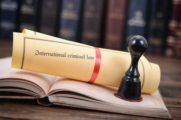 International criminal law and notary seal on a wooden background. — Stock Photo, Image