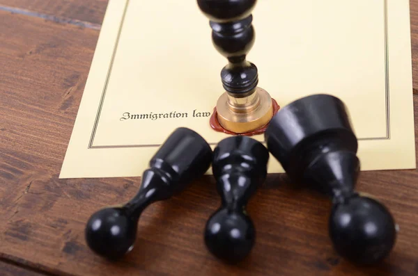 Notary seals and Immigration law on the wooden background.