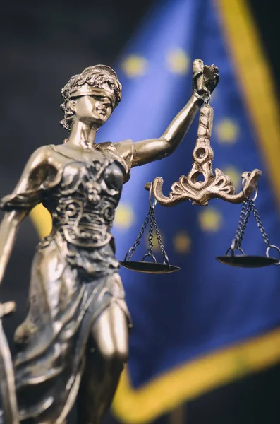 Scales of Justice, Justitia, Lady Justice in front of the European Union flag.