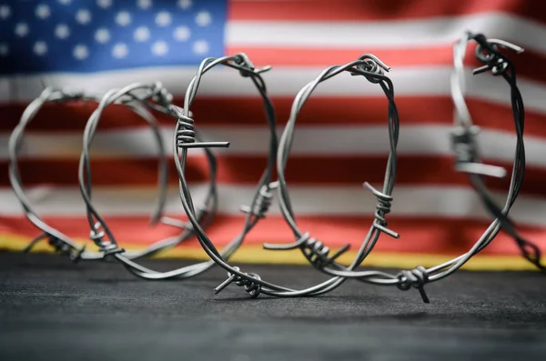 Barbed wire and United States of America flag , immigration stock concept — ストック写真