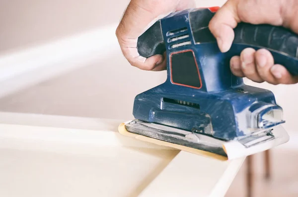 Orbital sander in use, sanding old door for a new lick of paint. — Stock Photo, Image
