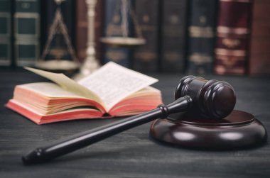 Judge Gavel, Law book and Scales of Justice on a black wooden background