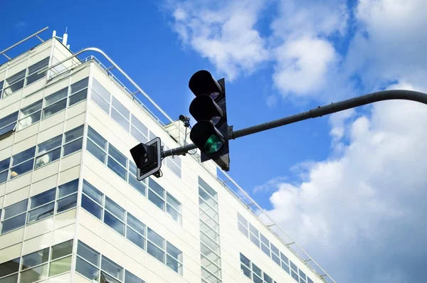 Traffic light green with active against the sky