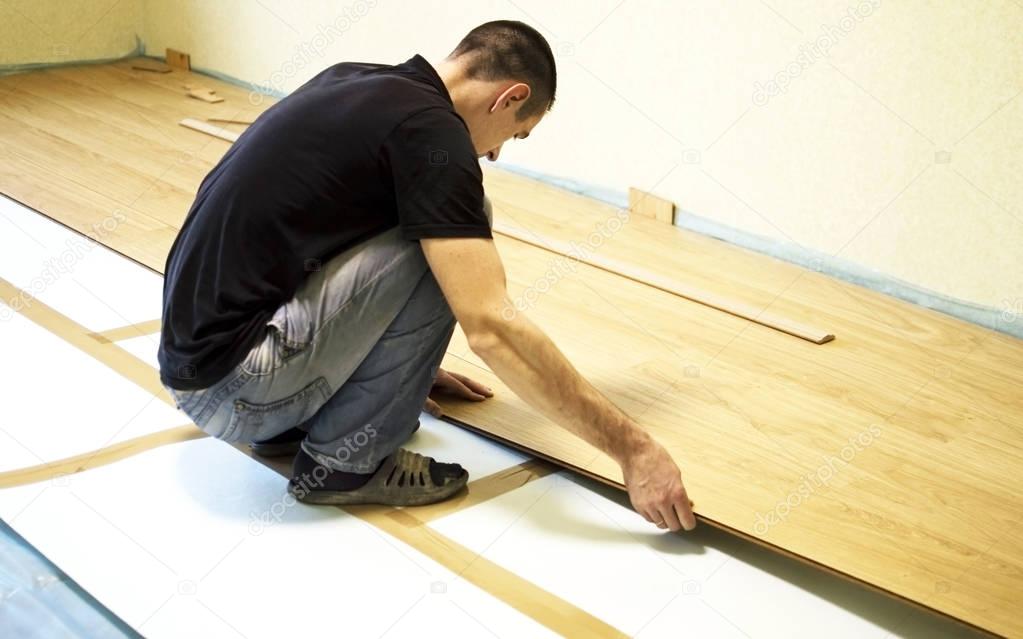 The process of installing laminate wooden on the floor 