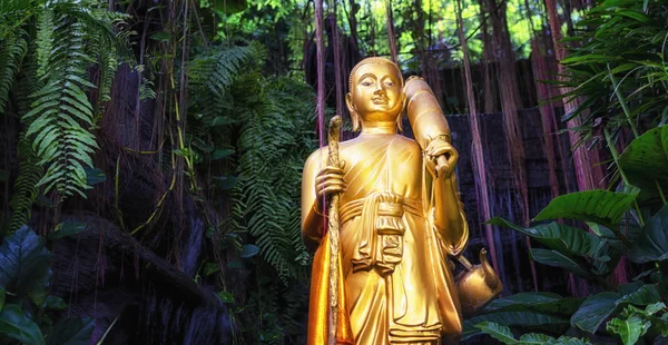 Golden Buddha statue and small artificial waterfall at the Golde — Stock Photo, Image