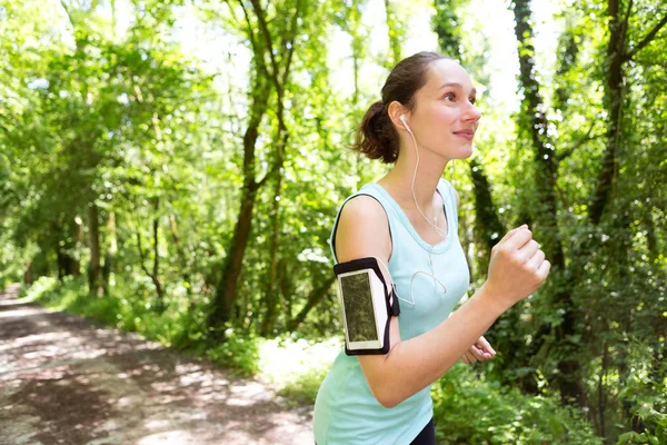 Woman running in forest — Stock Photo, Image