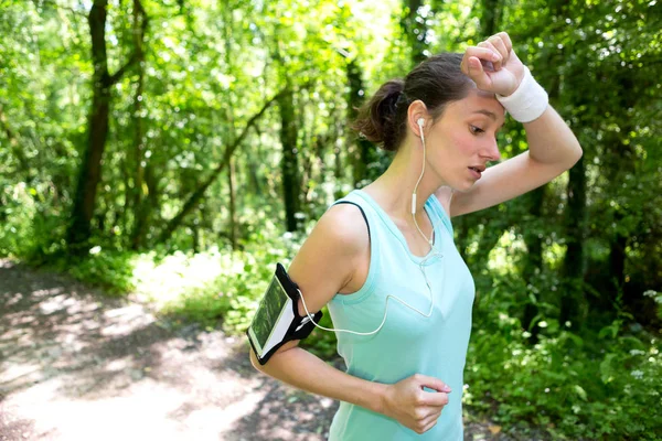 Attractive woman running in the forest — Stock Photo, Image