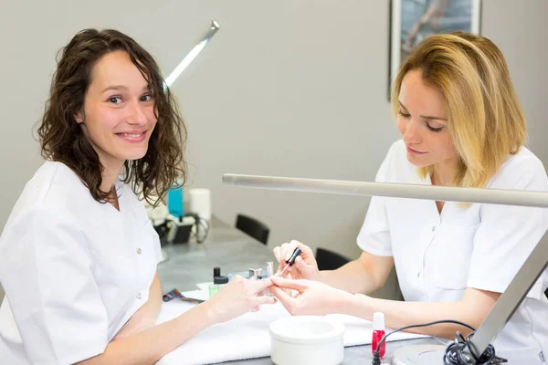 View of Young attractive beautician students practising during courses