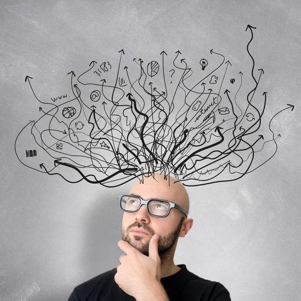 Man with brainstorming arrows over head Stock Image