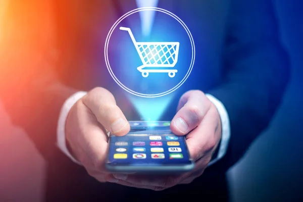 Virtual trolley going out of a smartphone - shopping online conc — Stock Photo, Image