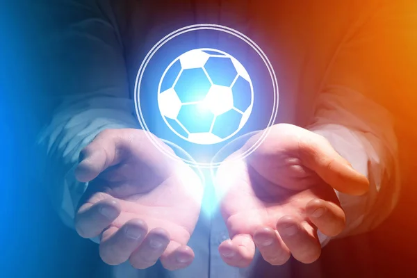 Fotbalový míč ikona nad rukou — Stock fotografie