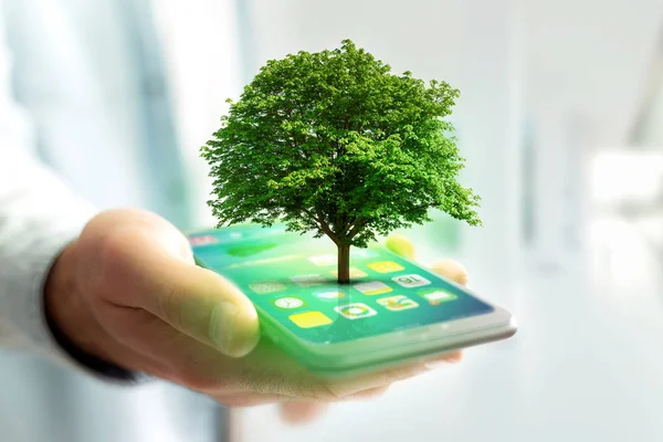 Groene boom going out of smartphone — Stockfoto