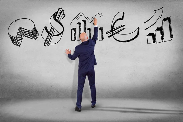 Businessman in front of wall writing — Stock Photo, Image