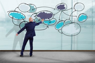 İşadamı bir iş grafik organ üzerinde yazma bir duvar önünde