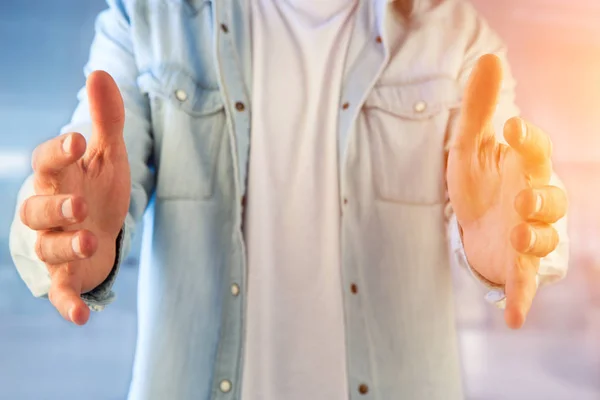 Young man giving an empty hand at the office — Stock Photo, Image