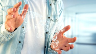 Bir elini tutarak bir işadamı görünümünü dünya haritası üzerinde futuristik bir arayüze çizilmiş.