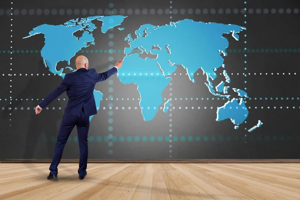 View of Businessman in front of wall with a Connected world map