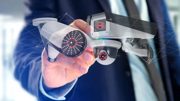 Bir güvenlik kamera sistemi ve ağ bağlantı - 3d render tutan bir işadamı görünümünü