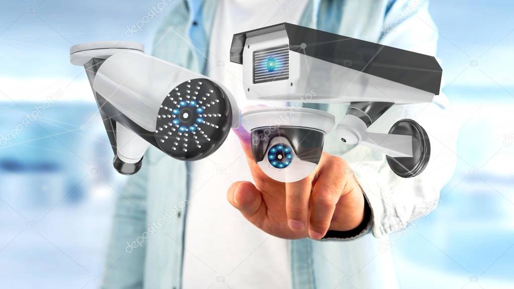 View of a Businessman holding a Security camera system and network connection - 3d rendering