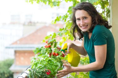 Young woman hoping not killing plant with chemistral product  clipart