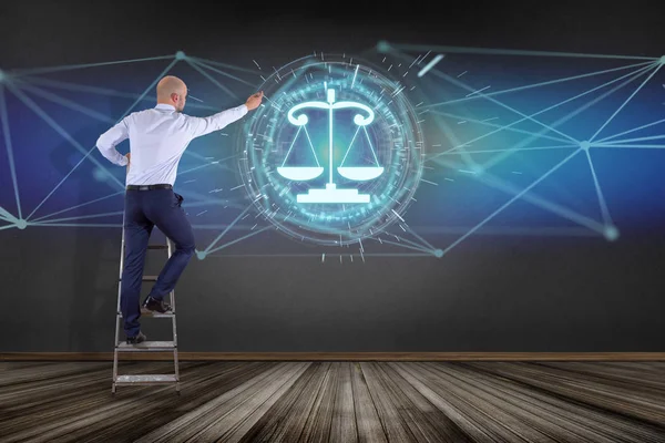 Businessman in front of wall with justice balance icon on futuristic interface