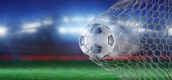 View of football ball in net of goal on blurred background