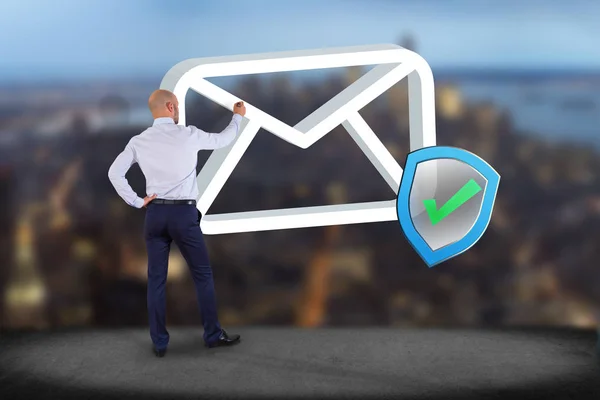Businessman in front of wall with approved and verified email symbol