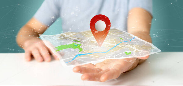 Man holding a 3d rendering pin holder on a map