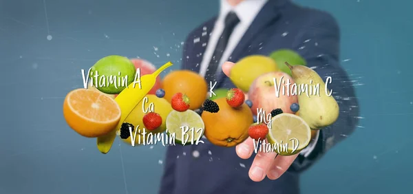 Επιχειρηματίας που κατέχουν φρούτα και βιταμίνες - 3d απόδοση — Φωτογραφία Αρχείου