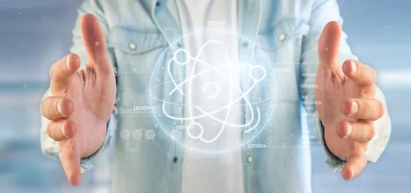 Businessman holding an atom icon surrounded by data — Stock Photo, Image