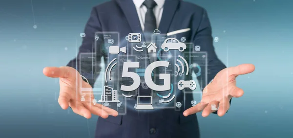 Businessman holding a 5G connection with data surrounding - 3d r Stock Photo