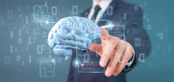 Affärsman som innehar en artificiell intelligens hjärna med data - Royaltyfria Stockfoton