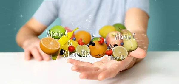 Businessman holding Fruits and vitamins - 3d rendering — 스톡 사진