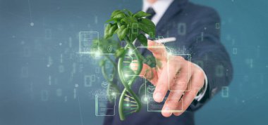 View of a Businessman holding a DNA growing as a plant - 3d rendering