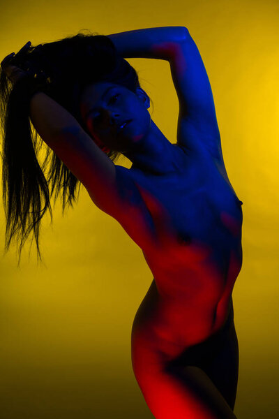 Beautiful petite Filipino woman lit in blue and red