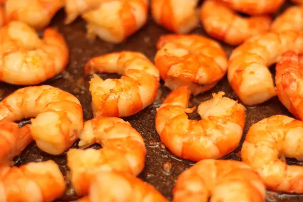 Fried Argentinean tiger prawns with garlic in olive oil in a pan