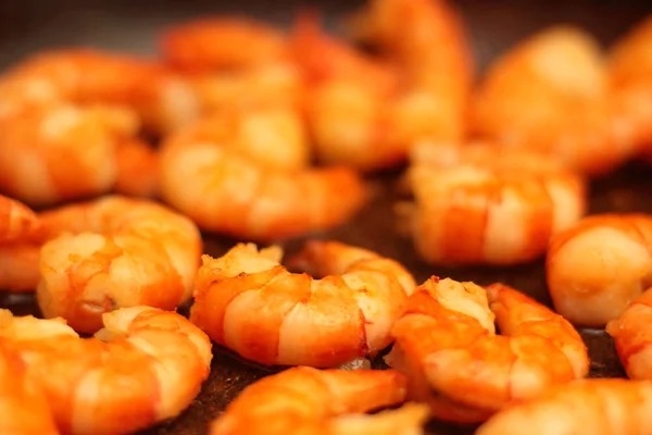 Fried Argentinean tiger prawns with garlic in olive oil in a pan